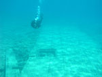 Diver inspects side section featuring wooden arch and gangway hatch.
