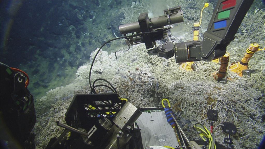 ROV Hercules samples fluid from a deep sea vent using an isobaric gas tight sampler. ROV Hercules is equipped with a variety of tools that are operated by crew on the E/V Nautilus, enabling them to collect samples and conduct other deep sea research.